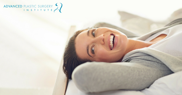 Smiling Model Lying on Bed Looking Backwards