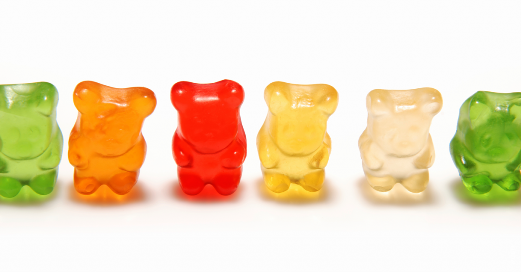 Multi colored gummy bear candies in a row