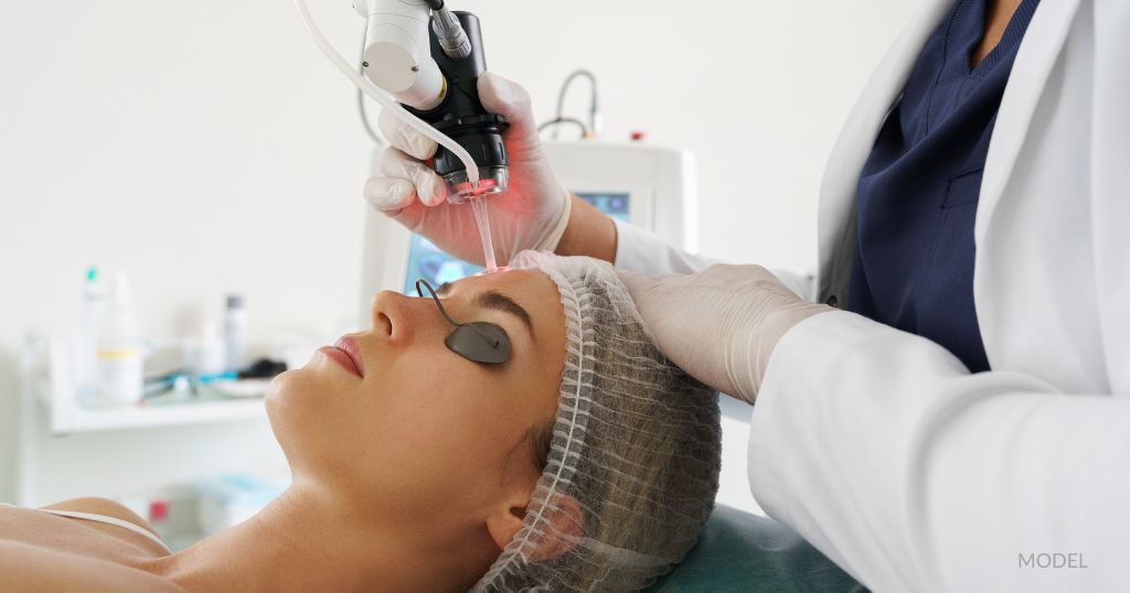 A woman is receiving laser skin resurfacing treatment on her face. (Model)