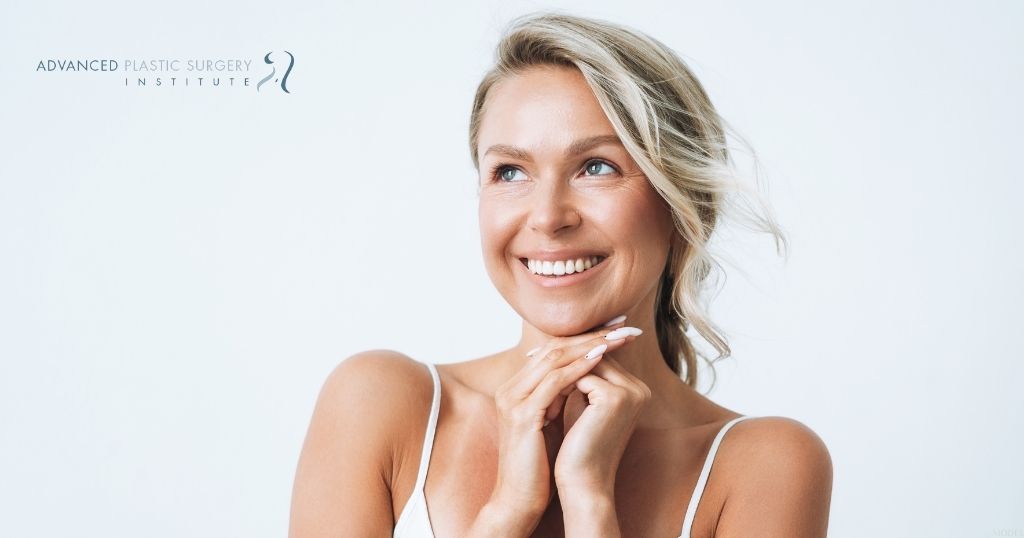 Woman smiling with hands under her face (MODEL)