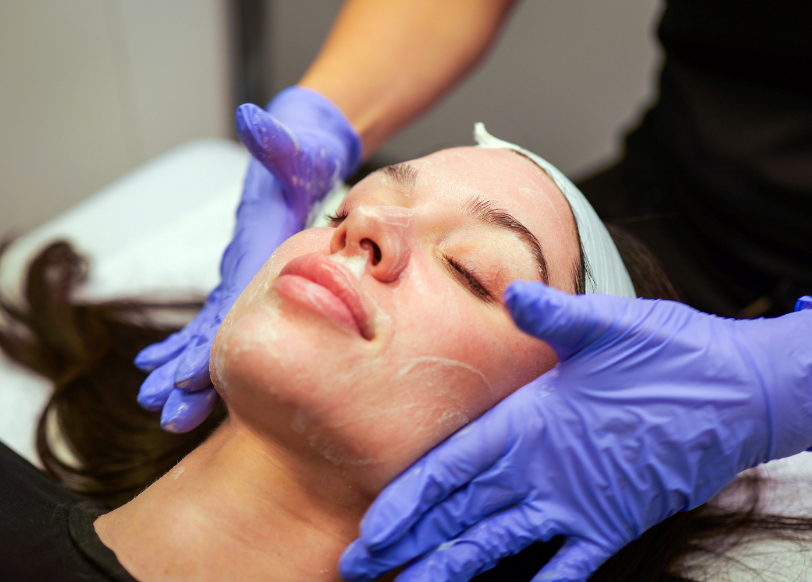 Staff performing a facial treatment