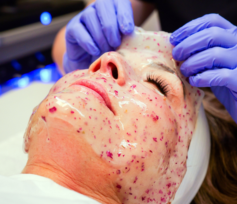 Staff performing a facial treatment