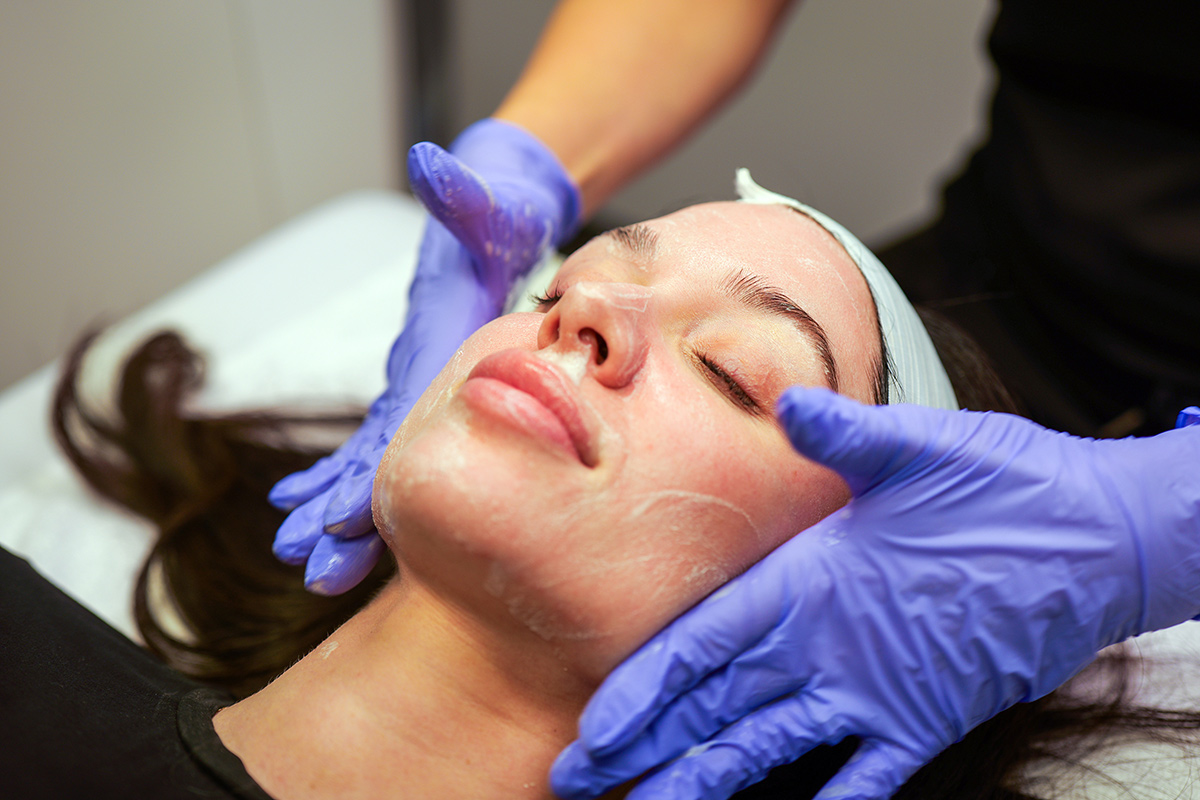Advanced Plastic Surgery Institute professional performing a facial treatment