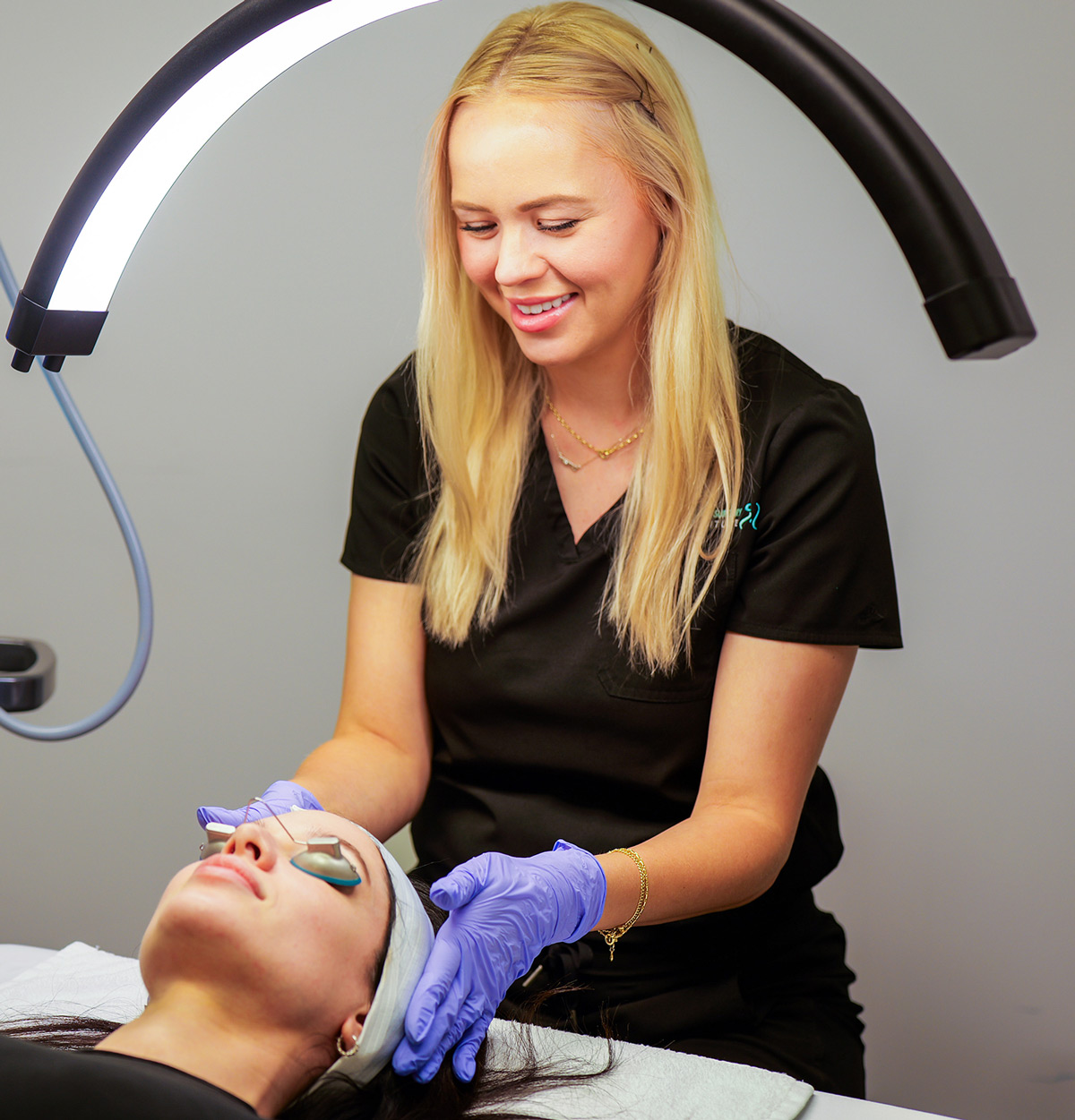 Staff preforming facial treatments