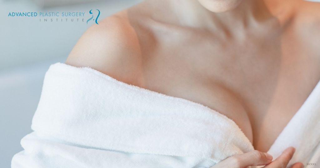 A woman in white robe with a close up to her chest. (Model)